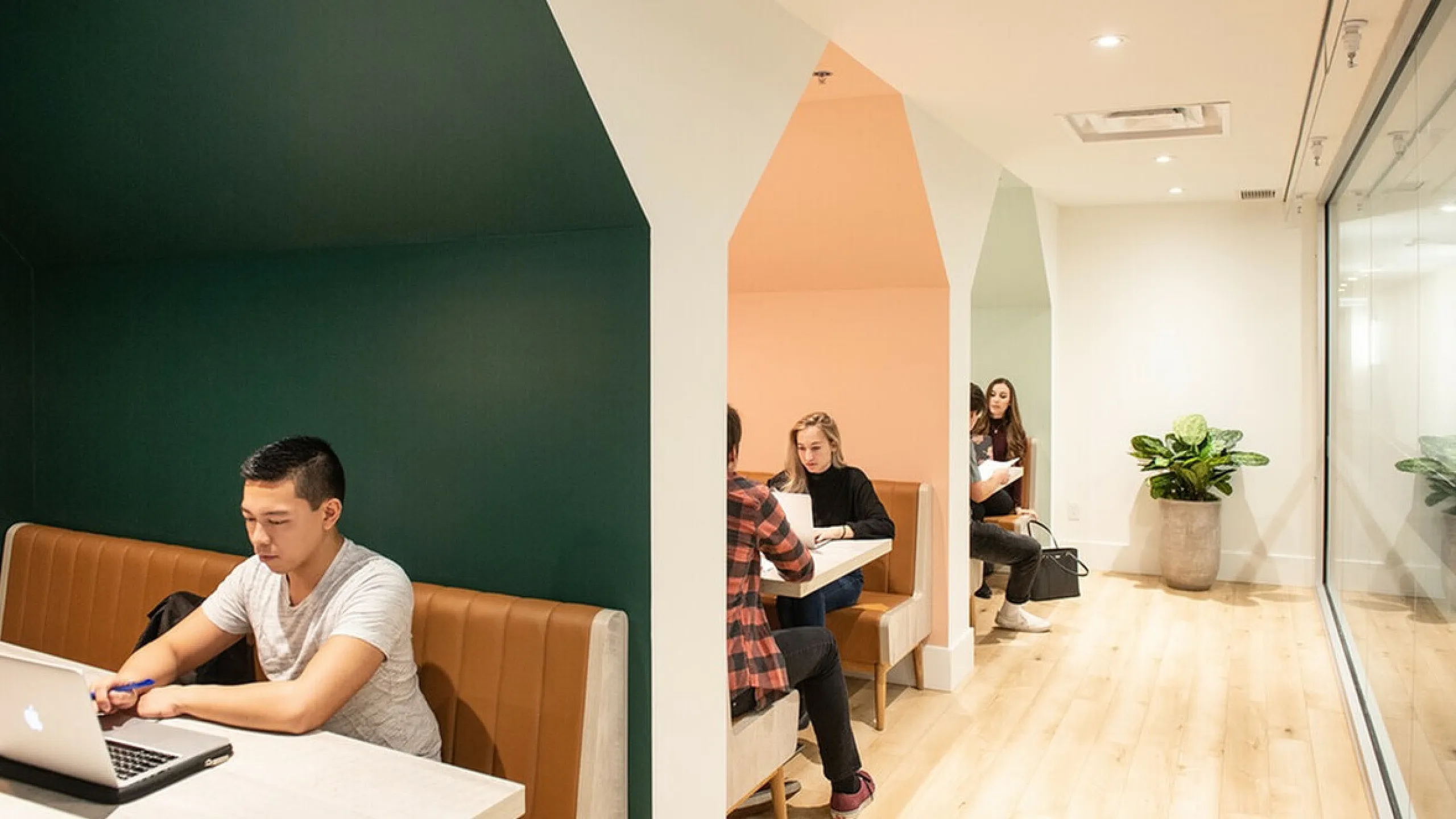 Inviting coworking area with modern booths and warm lighting perfect for collaborative sessions.